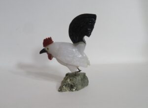 White rooster figurine with black tail